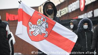Протестующая с бело-красно-белым флагом в Минске