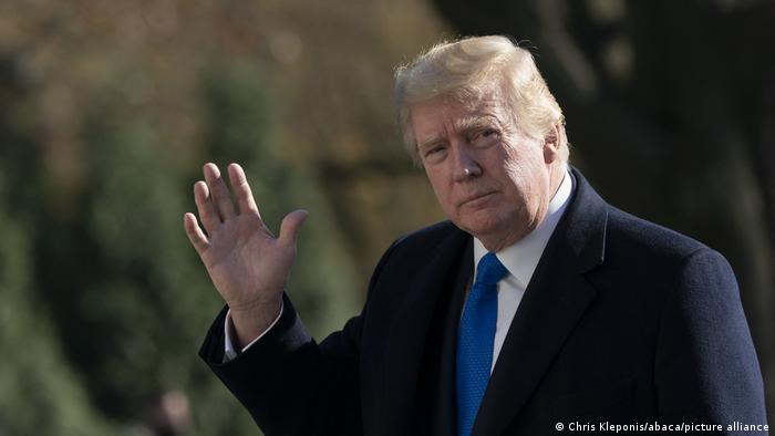 US President Donald Trump waves as he returns to the White House