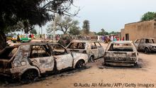 The wreckage of cars damaged by an attack on a market are seen on September 20, 2018, in Amarwa, some 20 kilometres (12 miles) from Borno state capital Maiduguri. - Nine people were killed and nine others injured when Boko Haram fighters raided Kalari Abdiye and Amarwa villages in northeast Nigeria, the civilian militia said. (Photo by Audu Ali MARTE / AFP) (Photo credit should read AUDU ALI MARTE/AFP via Getty Images)