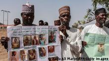 Parents and relatives hold portraits of their girls during a commemoration five years after they were abducted by Boko Haram Jihadists group on April 14, 2019 at the Chibok Local Government. - On April 14, 2014, gunmen stormed the Chibok girls' boarding school, kidnapping 276 pupils aged 12-17, 57 of whom managed to escape by jumping from the trucks. After negotiations with Boko Haram, 107 of the girls either escaped, were released in exchange for prisoners or were recovered by the army. 112 Chibok girls are still missing. (Photo by Audu Ali MARTE / AFP) (Photo credit should read AUDU ALI MARTE/AFP via Getty Images)