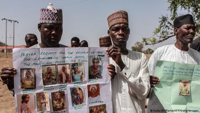 Parents and relatives hold portraits of their girls abducted by Boko Haram in Chibok