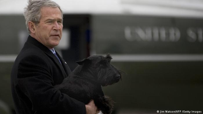President George W. Bush holds his dog Barney