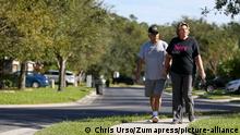 November 19, 2020, Hudson, Florida, USA: Vickie Martinez, 65, right, along with her husband Lee, 70, walk in their Hudson neighborhood Thursday, Nov. 19, 2020. Lee has been diagnosed with mixed Alzheimer s and vascular dementia and requires constant attention from Vickie. Vickie has found that the pandemic has isolated them further as they do not have family nearby. (Credit Image: Â© Chris Urso/Tampa Bay Times via ZUMA Wire
