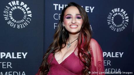 Jazz Jennings in a revealing purple dress, poses for photographers at the Paley Center for Media