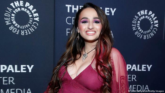 Jazz Jennings in a revealing purple dress, poses for photographers at the Paley Center for Media