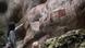 A person points at rock art on the face of a cave in Colombia A person points at rock art on the face of a cave in Colombia
