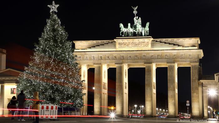 Christmas tree in front of the illuminated Brandenburg Gate, Berlin, Germany