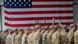 US troops in Germany stand in front of an American flag US troops in Germany stand in front of an American flag