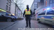 A Frankfurt police officer directs traffic away from the exclusion zone