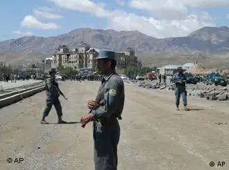 Afghan police and US military cordon off an area after a suicide attack in Kabul, Afghanistan, Tuesday May 18, 2010. A suicide car bomb blast ripped through a NATO convoy and public bus in the heavily fortified Afghan capital early Tuesday, killing at least 12 people including five foreigners, officials said. (AP Photo/Amir Shah)