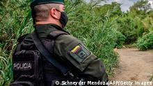 Colombian police officers stand guard at the trochas -illegal trails on the border between Colombia and Venezuela- near the Simon Bolivar international bridge, in Cucuta, Colombia, on October 14, 2020. (Photo by Schneyder MENDOZA / AFP) (Photo by SCHNEYDER MENDOZA/AFP via Getty Images)