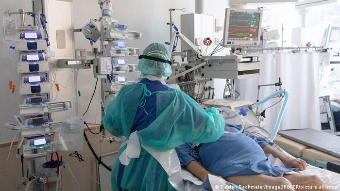 A health care worker attends to a COVID patient in an ICU in Bavaria