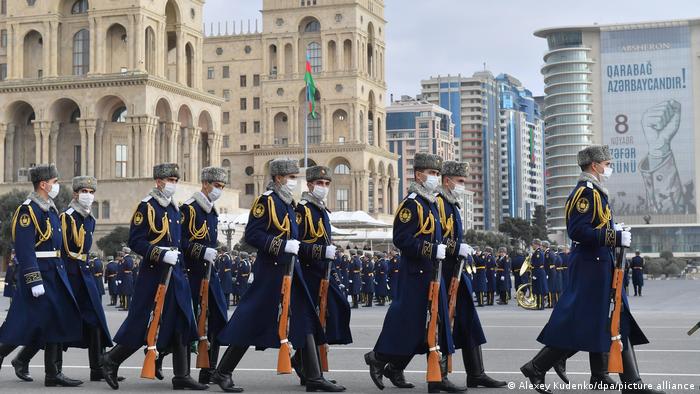Azerbaijani servicemen walk before a military parade to celebrate the victory in Nagorno-Karabakh War, in Baku