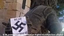 In this photo provided by the Wassmuth Center for Human Rights, a swastika sticker is seen on a sculpture at the Idaho Anne Frank Human Rights Memorial in Boise, Idaho on Tuesday, Dec. 8, 2020. Boise police are investigating after the memorial was defaced by swastika stickers earlier this week. The stickers, which included the words, we are everywhere as well as the Nazi insignia, were discovered Tuesday morning by a visitor to the memorial in downtown Boise. (Wassmuth Center for Human Rights via AP)