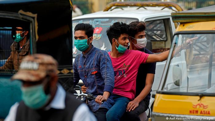 People wearing face masks as a preventive measure against COVID-19 on a street in Karachi