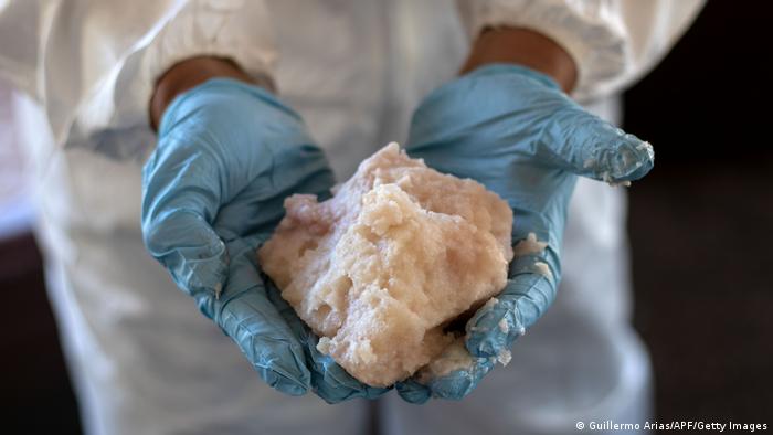 A Mexican army expert shows crystal meth paste at a clandestine laboratory near la Rumorosa town in Tecate, Mexico, on August 28, 2018