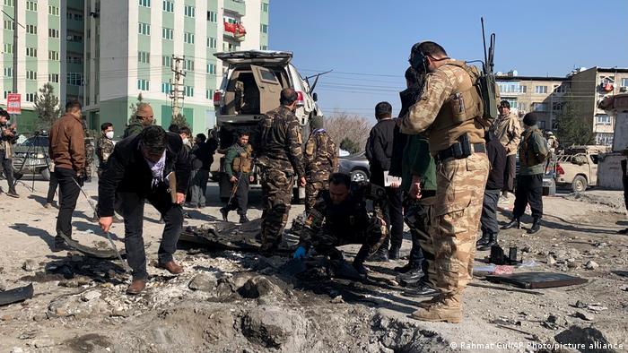 An Afghan security officer keeps watch at the site of a blast in Kabul, Afghanistan December 15, 2020.