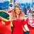 Picture of a woman dressed in red, identified as American singer Mariah Carey, against a Christmas backdrop. 