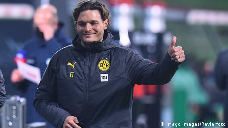 Edin Terzic gives a smile and a thumbs up while Borussia Dortmund coach