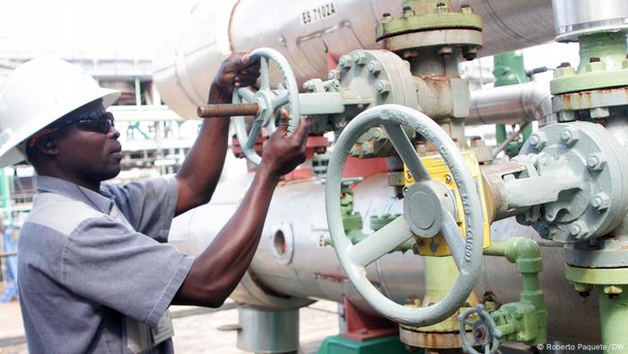 An African gas industry worker opening a pipeline