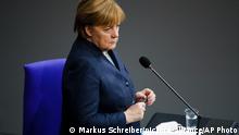 German Chancellor Angela Merkel answers questions of lawmaker about German government's policy at the parliament Bundestag, in Berlin, Germany, Wednesday, Dec. 16, 2020. Germany has entered a harder lockdown, closing shops and schools in an effort to bring down stubbornly high new cases of the coronavirus. (AP Photo/Markus Schreiber)