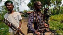 epa03485146 Militiamen of Mai Mai rebel group who has been fighting alongside the Congolese government forces stand guard in a small village near the town of Minova, some 45km from the provincial capital Goma, where the government forces are based, Democratic Republic of Congo, 24 November 2012. The M23 rebel group, who has taken control of Goma and nearby town of Sake already, has advanced to the next town of Kirotshe, only about 10km away from Minova where Congolese government forces have retreated to. African leaders from the Great Lakes region including Congolese President Joseph Kabila began talks over Congo on 24 November, but Paul Kagame of Rwanda who has been widely accused of supporting the M23 rebels, did not attend the meeting. EPA/DAI KUROKAWA ++
