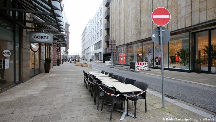 Tables and chairs stand empty in downtown Hamburg