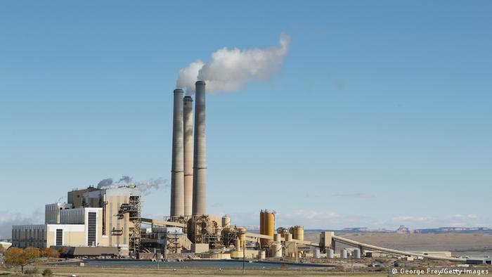 Smoke billows from the chimney stacks of a coal-fired power plant 