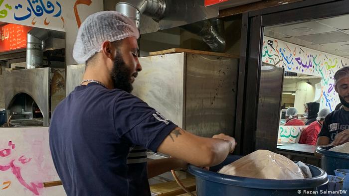 An employee with dough in Mona Mallah's bakery in Beirut