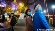 Duan Ling, 36, and her husband Fang Yushun walk on a street, almost a year after the global outbreak of the coronavirus disease (COVID-19) in Wuhan, Hubei province, China December 16, 2020. Fang, who is a doctor, contracted COVID-19 and recovered after receiving treatment while working during the outbreak. Picture taken December 16, 2020. REUTERS/Aly Song Story: https://bit.ly/2KzLSi7
