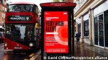 A bus waits beside a notice for 'Tier 3' or 'Very High' alert coronavirus restrictions displayed on the digital advertising screen of a bus stop on Kensington High Street in London, England, on December 18, 2020. Tier 3 restrictions began in London on Wednesday amid authorities' concern over escalating numbers covid-19 positive tests in the city. Shops are allowed to remain open in Tier 3 areas, but hospitality businesses are limited to takeaway and delivery service only, and entertainment venues including theatres and cinemas must close. (Photo by David Cliff/NurPhoto)