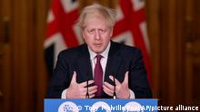 Britain's Prime Minister Boris Johnson speaks during a news conference in response to the ongoing situation with the coronavirus (COVID-19) pandemic, inside 10 Downing Street, London, Saturday, Dec. 19, 2020. Johnson says Christmas gatherings can’t go ahead and non-essential shops must close in London and much of southern England as he imposed a new, higher level of coronavirus restrictions to curb rapidly spreading infections. (Toby Melville/Pool Photo via AP)
