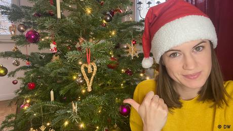 Rachel Stewart in Santa hat in front of tree