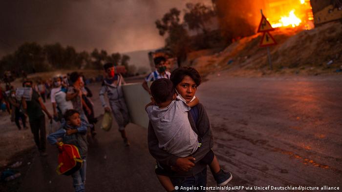 Children flee the burning Moria camp