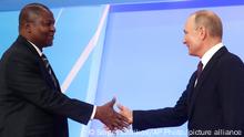 Russian President Vladimir Putin, right, shakes with President of the Central African Republic Faustin Archange Touadera during a welcome ceremony of the Russia-Africa summit in the Black Sea resort of Sochi, Russia, Wednesday, Oct. 23, 2019. (AP Photo/Sergei Chirikov, pool photo via AP)