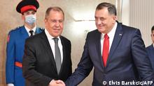 Russian Foreign Minister, Sergey Lavrov (L) shakes hands after meeting with chairman of Bosnia and Herzegovina's tripartite presidency, Milorad Dodik (R), in East-Sarajevo, late on December 14, 2020. - Minister Lavrov arrived in two-day official visit to Bosnia and Herzegovina, where he is scheduled to hold several meetings with country's top officials. (Photo by ELVIS BARUKCIC / AFP)