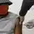 A man in a hat and mask receiving a Covid-19 vaccination in South Africa.