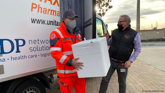 Health workers bring in vaccines to a German nursing home