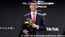 Cristiano Ronaldo poses with the trophy of player of the century at the Dubai Globe Soccer Awards ceremony, in Dubai, United Arab Emirates, Sunday, Dec. 27, 2020. (Fabio Ferrari/LaPresse via AP)