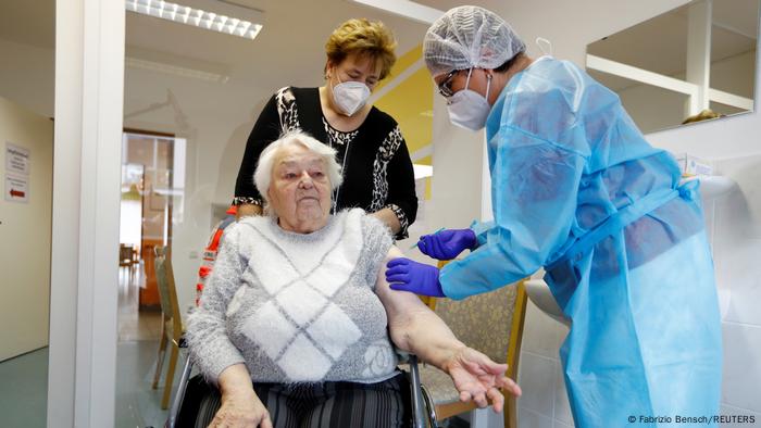An elderly German woman is vaccinated with vaccines BioNTech and Pfizer