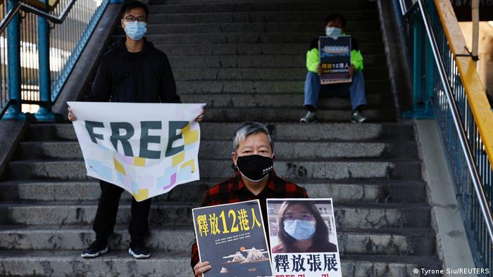 Pro-democracy supporters protest to urge for the release of 12 Hong Kong activists arrested as they reportedly sailed to Taiwan for political asylum and citizen journalist Zhang Zhan outside China's Liaison Office, in Hong Kong.