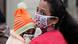 A woman and her child wearing face masks as a precaution against the coronavirus wait in a queue to update details of their Aadhar, a government identity card in Jammu, India A woman and her child wearing face masks as a precaution against the coronavirus wait in a queue to update details of their Aadhar, a government identity card in Jammu, India