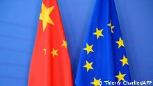 (FILES) In this file photograph taken on June 29, 2015, a Chinese flag (L) is draped beside the European Union (EU) flag during a EU-China Summit at European Union Commission headquarters in Brussels. - EU member states give political backing to Brussels' efforts to negotiate an investment pact with China on December 28, 2020, diplomats said, clearing the way for a deal. At a meeting of ambassadors, one said, the German EU presidency noted no member had raised a stop sign and the way for a political endorsement was thus cleared. (Photo by THIERRY CHARLIER / AFP)