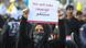 An Iraqi woman holds a sign during the funeral of Iranian military leader, Qassem Soleimani. An Iraqi woman holds a sign during the funeral of Iranian military leader, Qassem Soleimani.