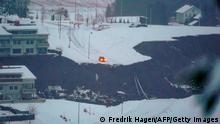 A car has stopped were the road has been swept away by a landslide in the town of Ask, Gjerdrum county, some 40 km northeast of the Norwegian capital Oslo. - Several houses were taken by a landslide in the early hours of December 30, several injured were taken to hospital for treatment and yet more people are listed as missing as the rescue mission continues. (Photo by Fredrik Hagen / NTB / AFP) / Norway OUT