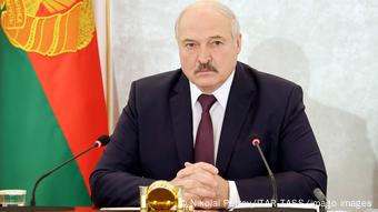 Александр Лукашенко сидит на фоне официального флага Беларуси Александр Лукашенко сидит на фоне официального флага Беларуси
