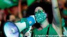 A demonstrator in favour of legalizing abortion uses a megaphone as the senate discuss an abortion bill, in Buenos Aires, Argentina, December 30, 2020. REUTERS/Agustin Marcarian