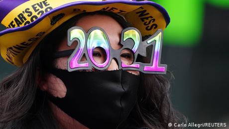 A woman wears 2021 numeral glasses in advance of New Year's eve