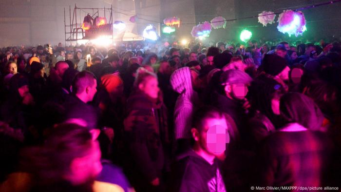 Massive crowd at a warehouse rave in France