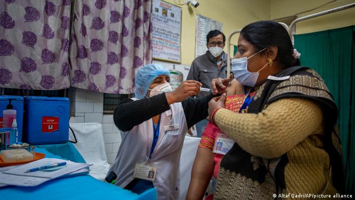 A health worker engages in a COVID vaccine delivery system trial in New Delhi